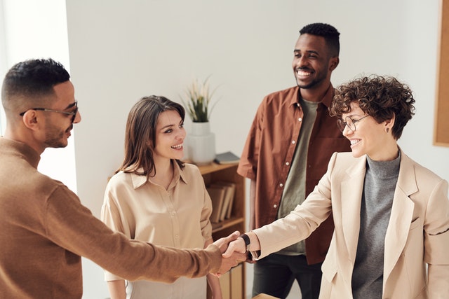 people shaking hands after agreement